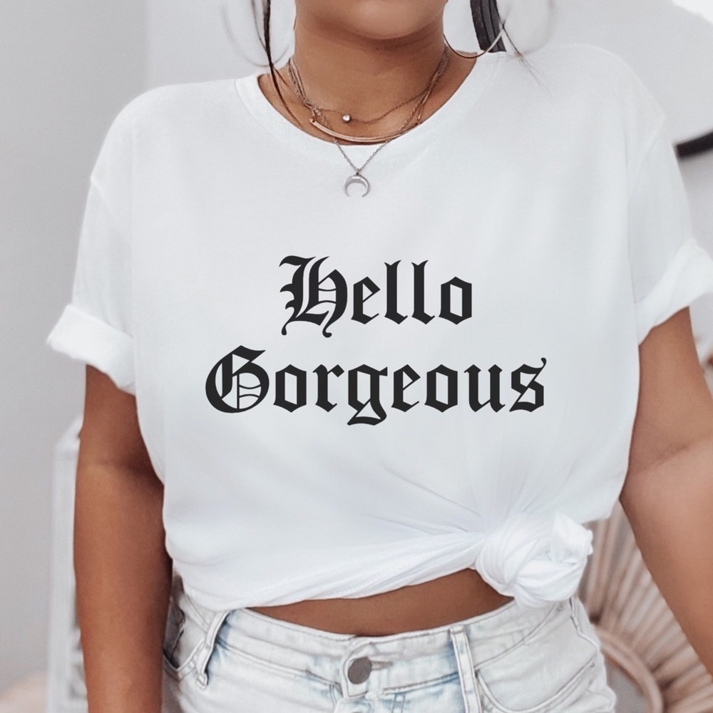 Get A Wink In Our Hello Gorgeous Short Sleeve Tee Shirt. It’s 100% Comfy Cotton
